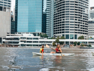 Family kayaking along the Brisbane River